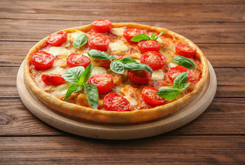 Pizza Margarita on wooden background
