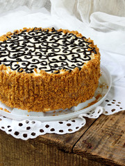 homemade cake with nut meringue butter cream and decorated with swirls of dark chocolate. Kyiv cake or cake Flight (Polet). copy space