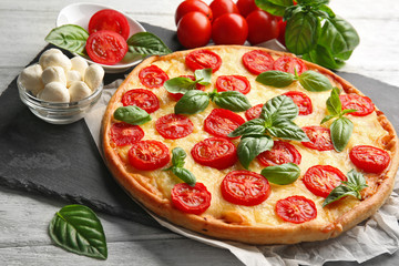 Fresh tasty pizza Margarita on slate plate, closeup