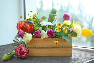 Beautiful flower composition in box on windowsill