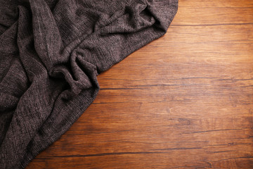 Grey knitted fabric on wooden background