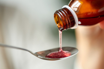 medication or antipyretic syrup and spoon