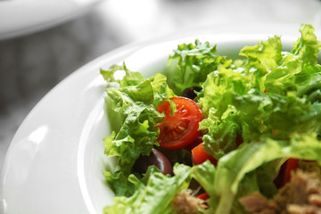 Fresh tasty salad in white plate, closeup
