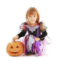 Cute girl with pumpkin in Halloween costume on light background