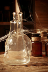 Vintage glass flask with spiderweb, closeup