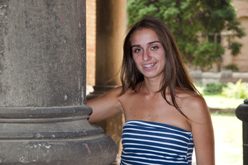 smiling pretty girl near column