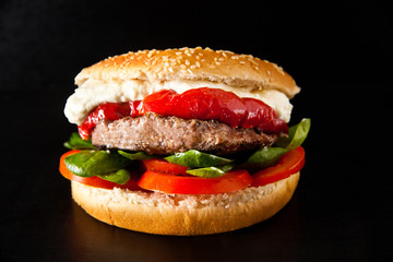 classic burger with meat on a black background