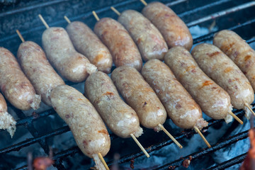 Raw Thai style sausage on stove.