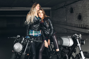 Fototapeta na wymiar Bikers women in leather jackets with motorcycles