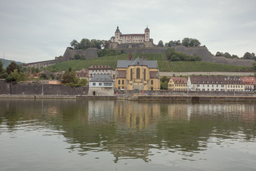 Fortress Marienberg and the St. Burkard church with vineyard on the bank of the Main river