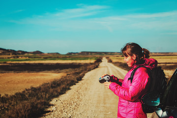 young woman travel by car on scenic road in winter