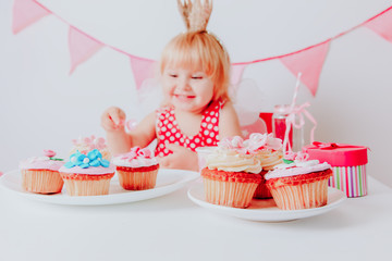 cute little girl with sweets at birthday party