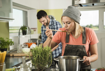 Couple cooking in kitchen at home