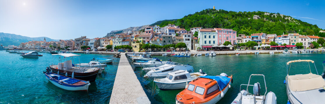 Wonderful romantic summer afternoon landscape panorama coastline Adriatic sea. Boats and yachts in harbor at cristal clear turquoise water. Baska on the island of Krk.