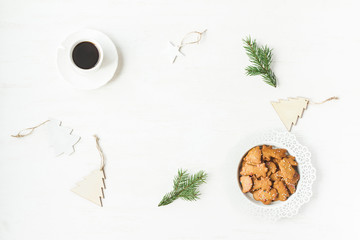 Christmas workspace. Cup of coffee, fir branches, christmas cookies. Flat lay, top view