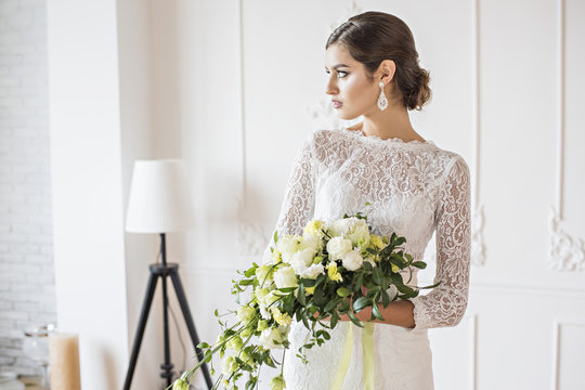 Wedding fashion bride with bouquet in hands