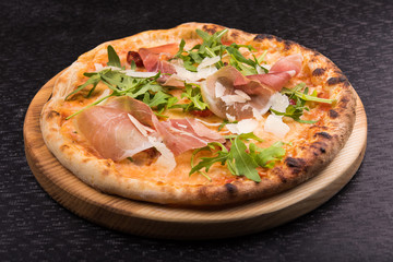 delicious italian pizza with arugula and prosciutto
