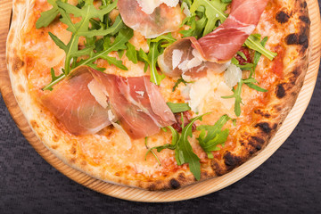 delicious italian pizza with arugula and prosciutto
