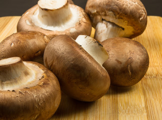 mushroom champignons on a wooden Board