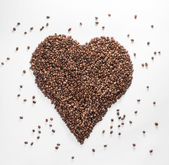 heart from coffee with scattered beans isolated on a white background