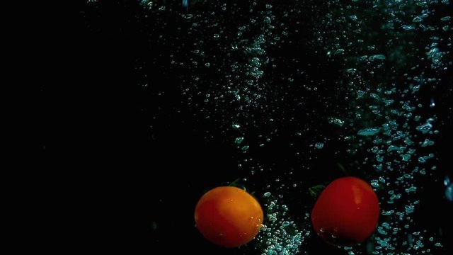 Fruit in water on a black background