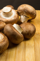 mushroom champignons on a wooden Board