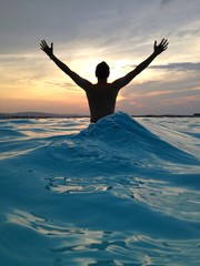 Man in sea in silhouette