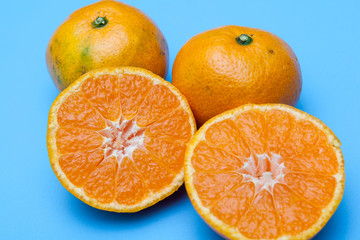 fresh and ripe oranges on blue backgrounds