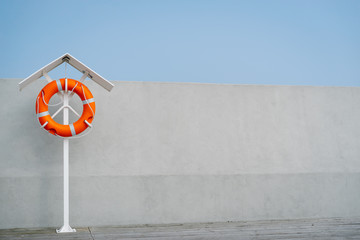 Orange life buoy on the pier