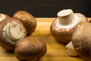 mushroom champignons on a wooden Board