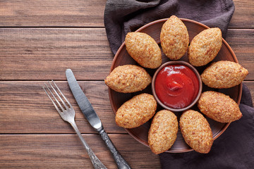 Kibbeh arabic beef, lamb, goat or camel meat stuffed bulgur kofta spicy meatball fried croquettes dinner food on rustic wooden table background