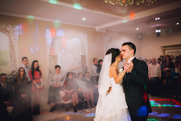 Romantic married couple bride and groom dancing at wedding reception on banquet
