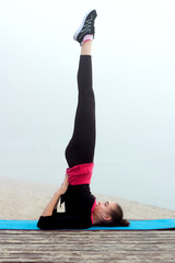 Young sporty woman doing yoga exercises during fitness workout o