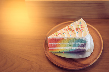 Rainbow cake in wood dish on the wood table