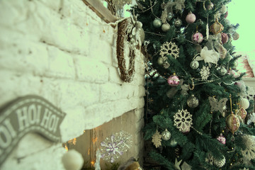 Fototapeta na wymiar Christmas tree about a brick fireplace