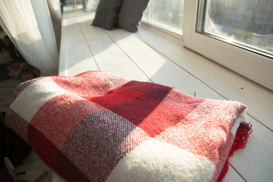 Checkered red plaid on white wooden windowsill