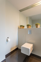 Fototapeta na wymiar Modern toilet with beige tiles