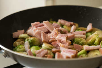 Brussels sprouts with bacon in frying-pan