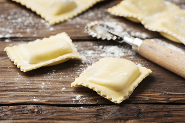 Uncooked ravioli on the wooden table
