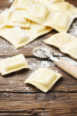 Uncooked ravioli on the wooden table