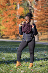 Smiling black girl wearing winter jacket in a park