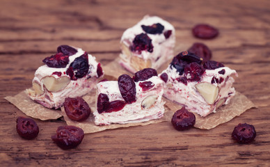 Soft nougat with forest fruits on rustic wooden surface