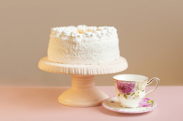 Homemade sweet pie with white cream on pink table.
