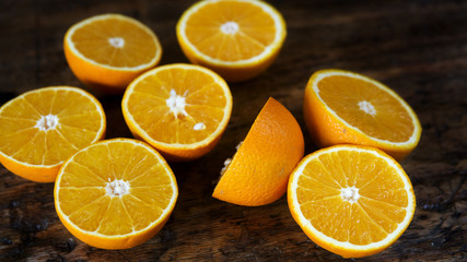 Fototapeta na wymiar oranges cut in half on a wooden table