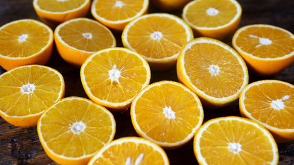 Naklejka na ściany i meble oranges cut in half on a wooden table