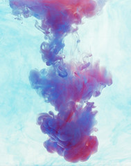 Color drop underwater creating a silk drapery. Ink swirling unde