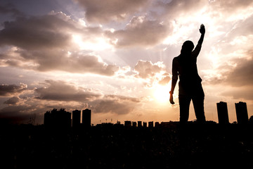 Woman in sunrise. Freedom concept.