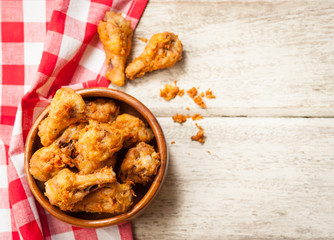 Fried crispy chicken wings on a wood table