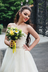 Fototapeta na wymiar Beautiful bride holding a bouquet