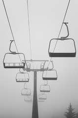 Cabs ropeway leading to heavy fog in mountain